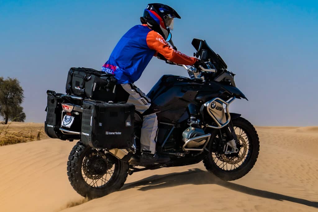 Photo shows BMW R1200GS ADV motorcycle riding in sand