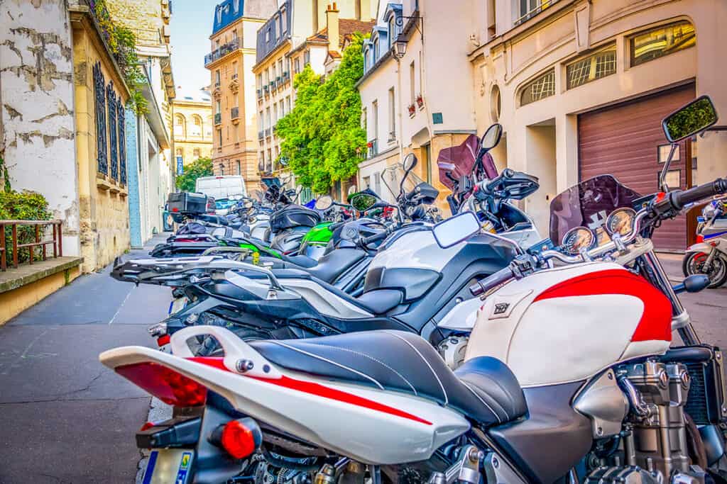 Multiple motorcycles parked on city street