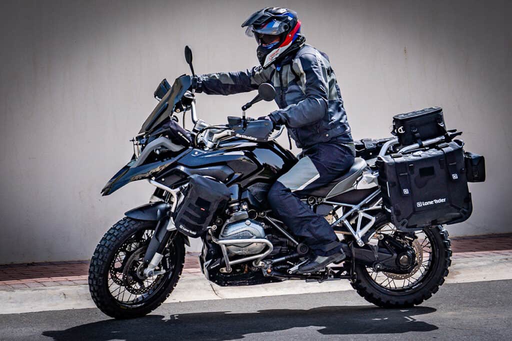 BMW R1200GS LC with seated rider on asphault