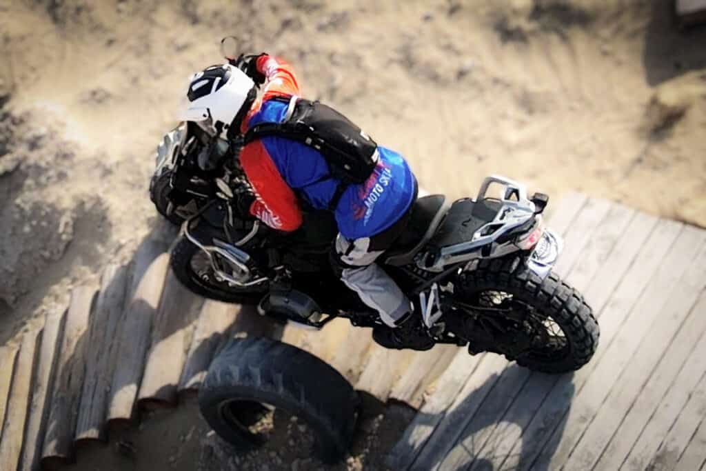 motorcycle rider riding an obstacle downhill